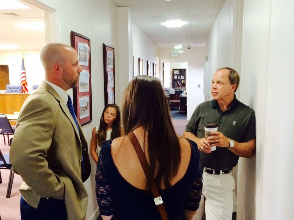 New White Plains baseball coach Wes Henderson (L) spends a few minutes with school board member Phil Murphy after being approved for the position Thursday. On the cover, Henderson and White Plains principal Andy Ward await the board's approval.