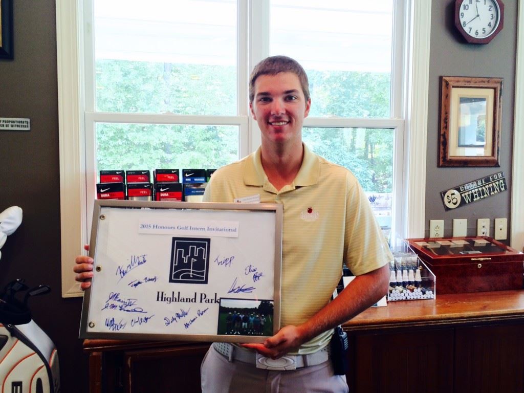 Cider Ridge intern John-Michael Russell displays the framed pin flag that commemorates his Honours Golf Intern Invitational victory. On the cover, Russell attends to daily business in the pro shop. 