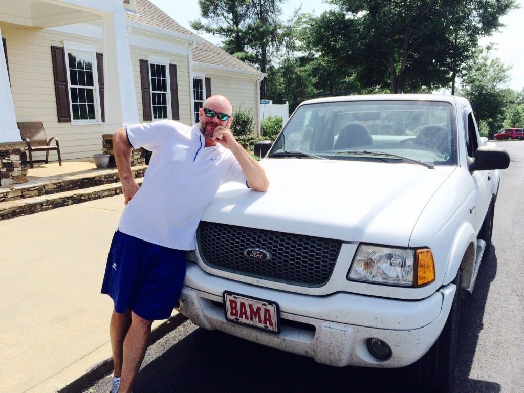 Ty Cole leans against what soon may be his former Ford truck after making a hole-in-one for $20,000 toward a new car Saturday in the Sunny King Charity Classic.