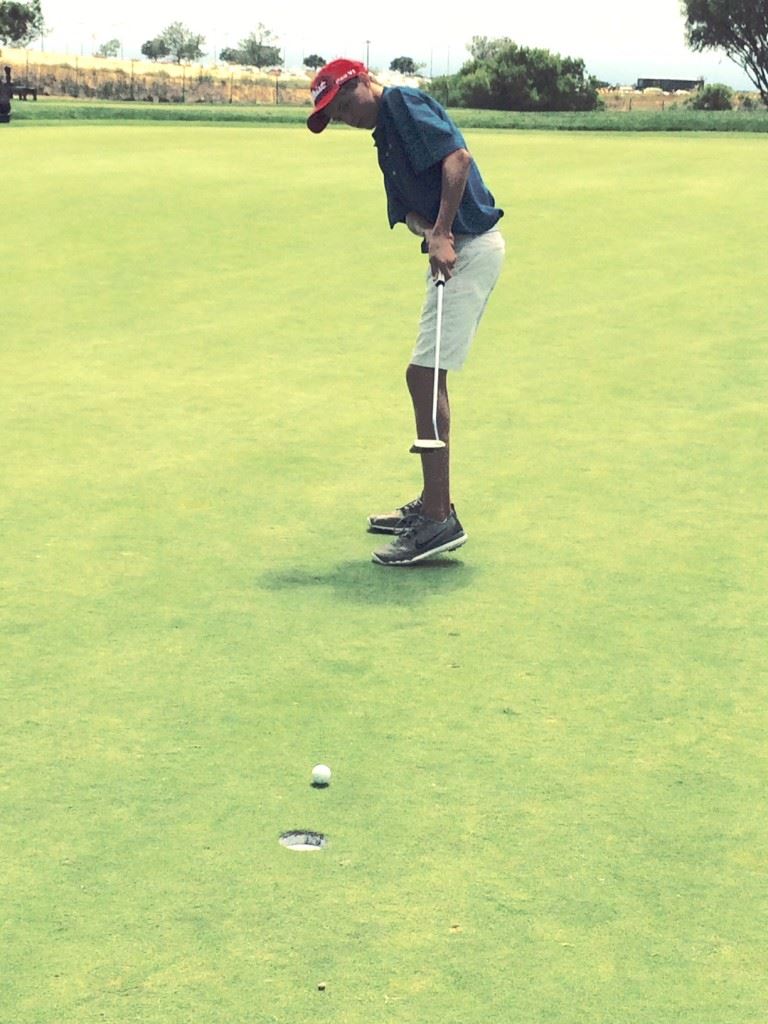 Jacob Lecroy drops his first birdie on the trip, sinking a five-foot putt on the par-3 11th during his practice round. (Photos by Lewis Lecroy)