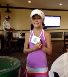 Erin Turley displays her second-place putting medal at Thursday's Drive, Chip & Putt subregional in Tennessee. On the cover, Turley awaits her turn to hit.