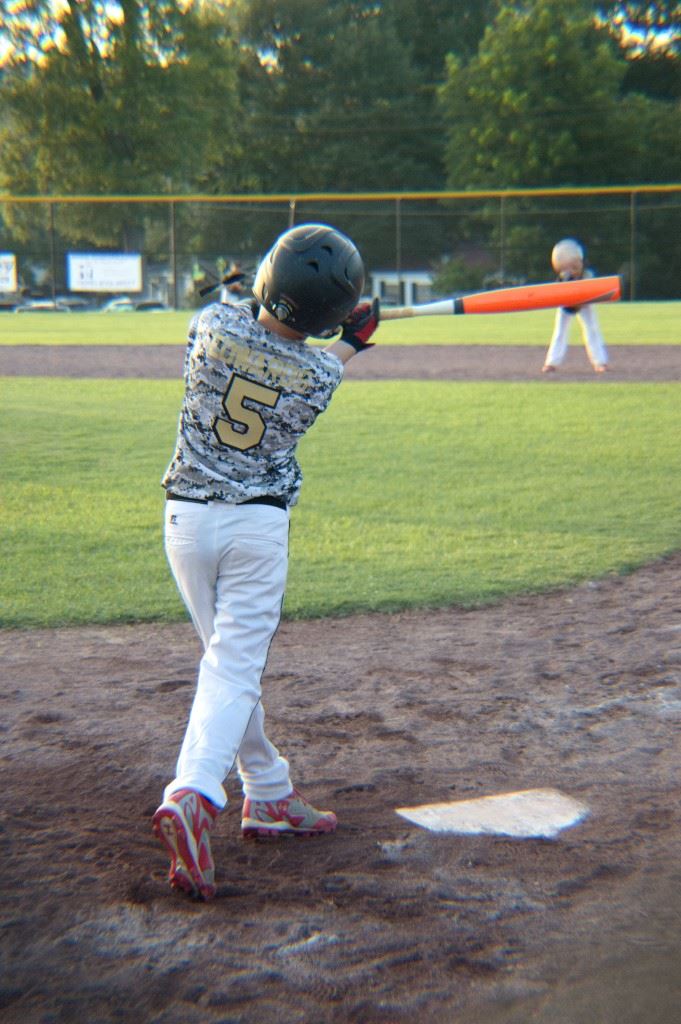 Oxford Black's left fielder Talan Edwards connects on his inside-the-park home run in his team's opening-round win in the Dixie Youth AAA Rookie State Tournament. 