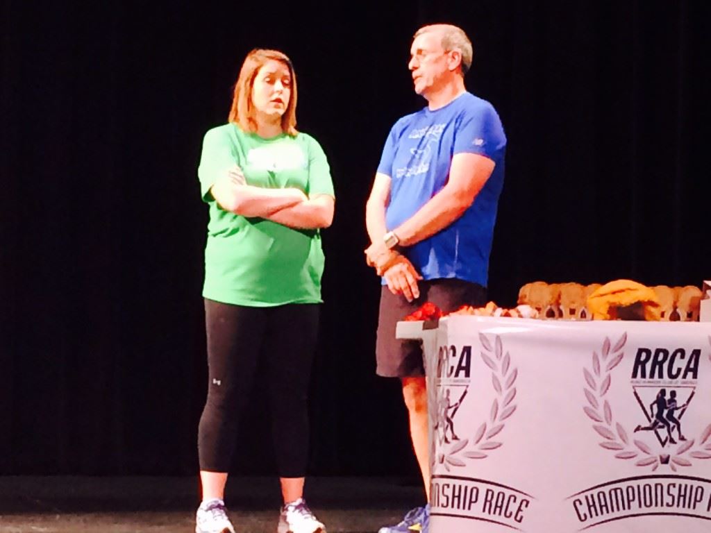 Neeli Faulkner, the presumptive next race director of the Woodstock 5K, talks with Anniston Runners Club president Robert Powers prior to Saturday's awards ceremony. Faulkner is expected to succeed Haley Gregg (cover), whose three-year term ended with Saturday's race.