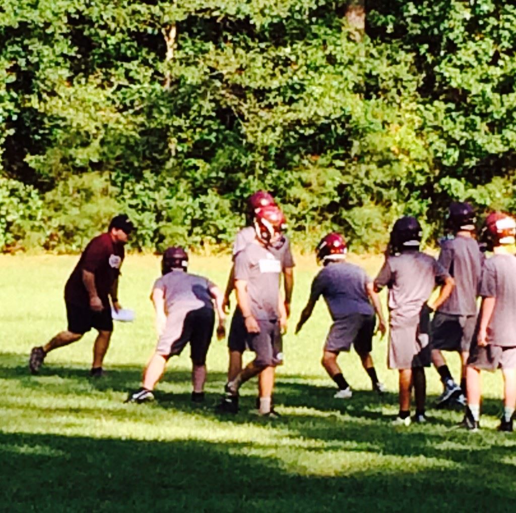 First-year Donoho coach Andy McWilliams conducts defensive drills on the first day of practice. On the cover, new White Plains coach Chris White oversee his first fall practice at Robertson Field.