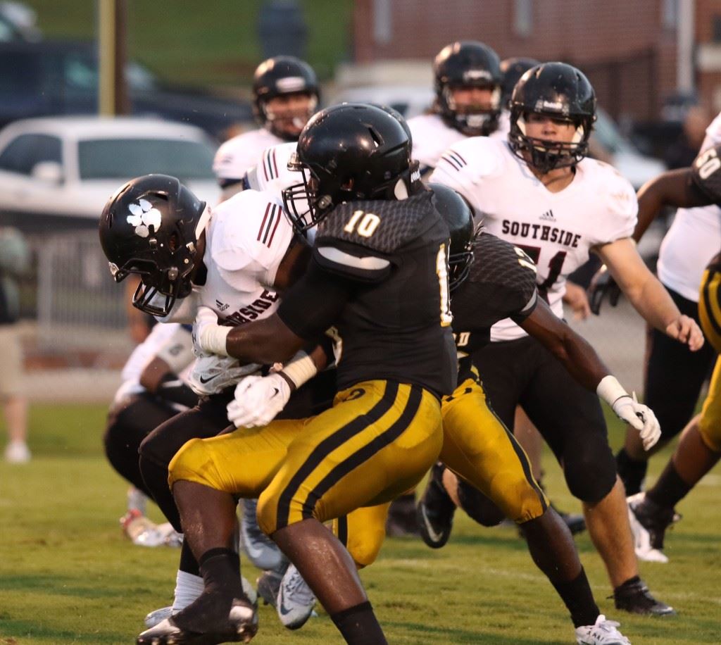 Kenney Britt (10) keyed an Oxford defensive effort that kept Southside out of the end zone in the second half. On the cover, sophomore quarterback Brody Syer fires one of his two second-half touchdown passes. (Photos by Kristen Stringer/Krisp Pics Photography).