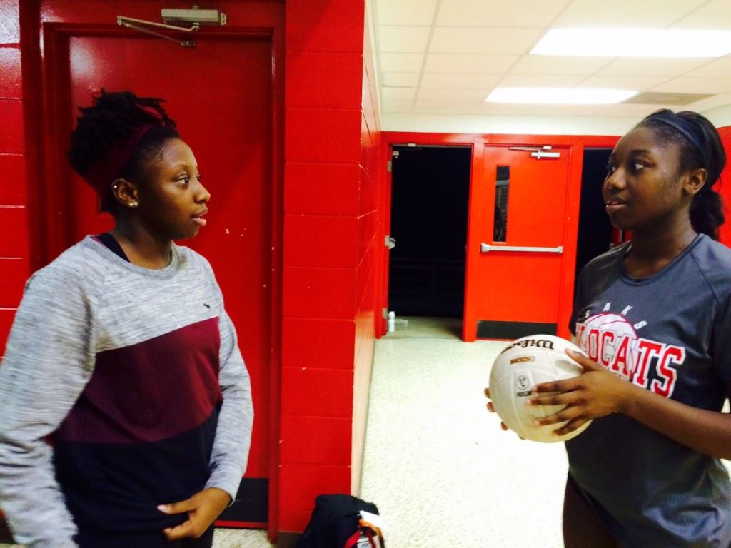 Saks senior Jordan Briskey (R) talks with her sister and Donoho junior high coach Destinee after the Lady Wildcats defeated the Lady Falcons in straight sets to win the Saks Invitational Saturday.