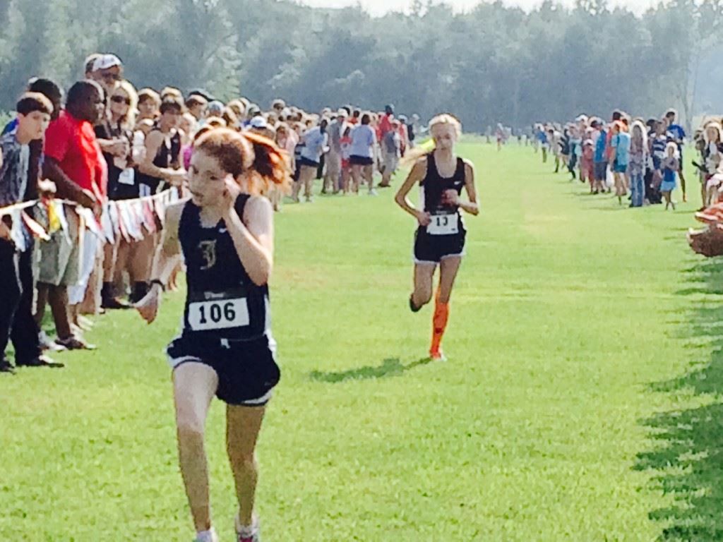 Jacksonville's Rebecca Hearn (106) sprints to the finish ahead of Alexandria's Abby Nunnelly in Saturday's Waffle House/Yellow Jackets Invitational girls race.