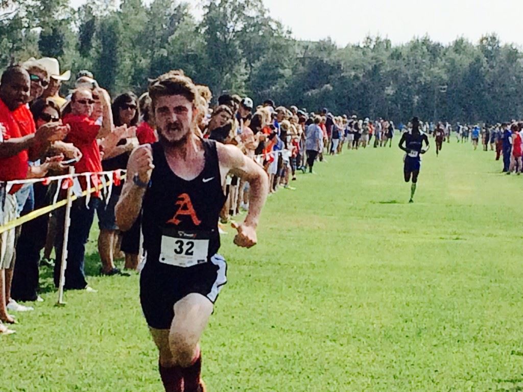 Alexandria's Lane Trapp pushes towards the finish for the boys wins in the Waffle House/Yellow Jackets Invitational Saturday at Oxford Lake. He ran seven seconds faster than he did finishing third on this course in the County Meet last fall. 