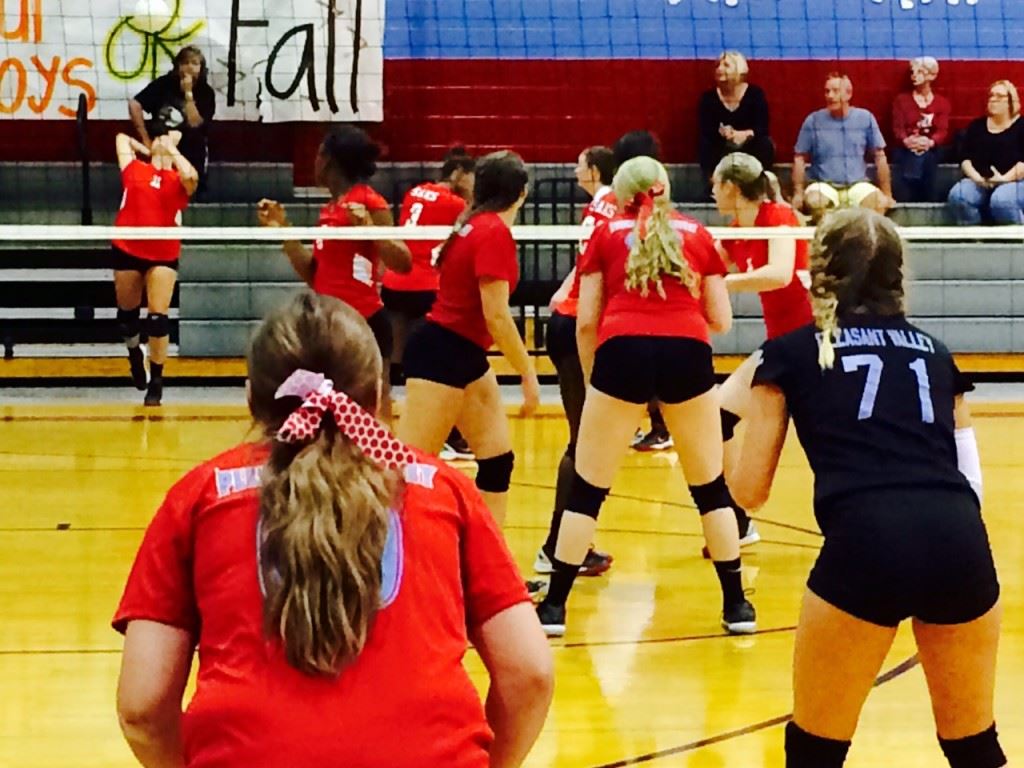 Pleasant Valley players Madison Bentley (71) and Taylor Williams prepare to receive the serve of Saks' Jaelyn Wilson during Saturday's title match.