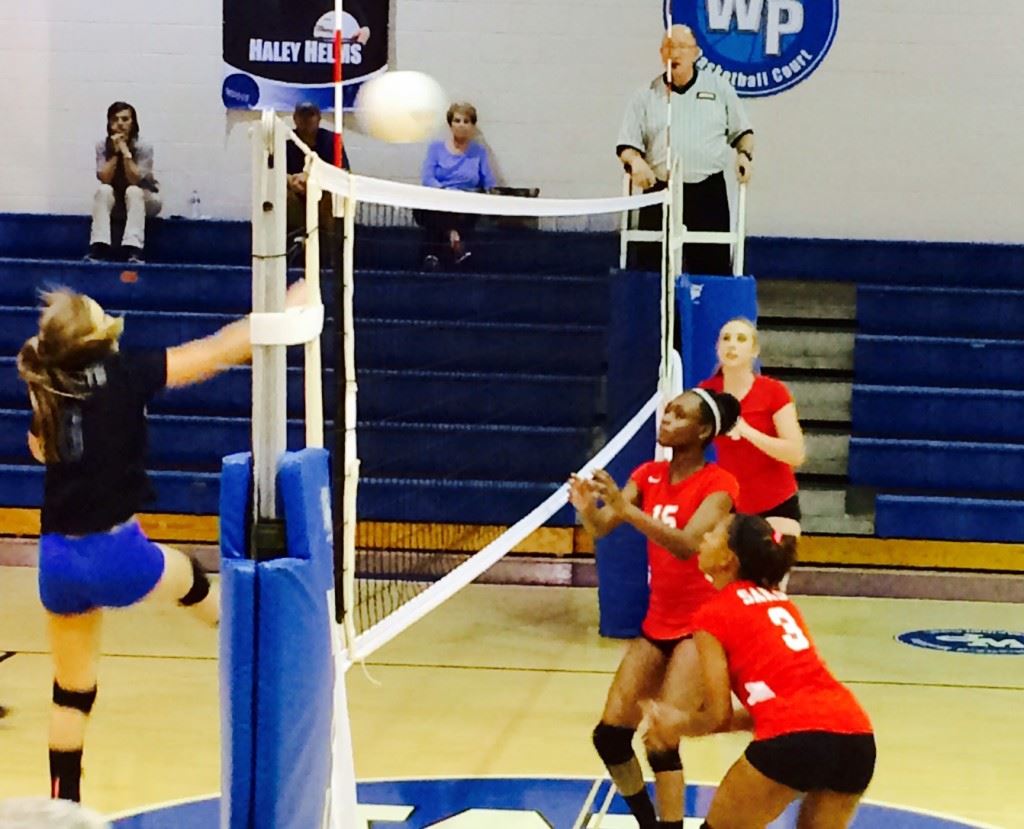 Saks' front line of (from left) Tayler Teague, LaMonica Noel and Baylee Snider line up at the net to defend the shot of White Plains' Carsyn Morrow.