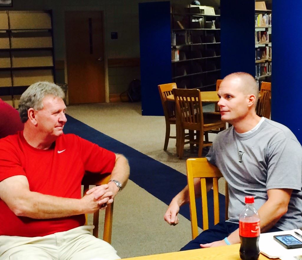 Saks coach Randy Law (L) and Jacksonville's David Clark discuss the affairs of the season while awaiting the results of the Calhoun County Volleyball Tournament seeding meeting Wednesday. Their teams were seeded second and third, respectively, behind No. 1 Oxford.