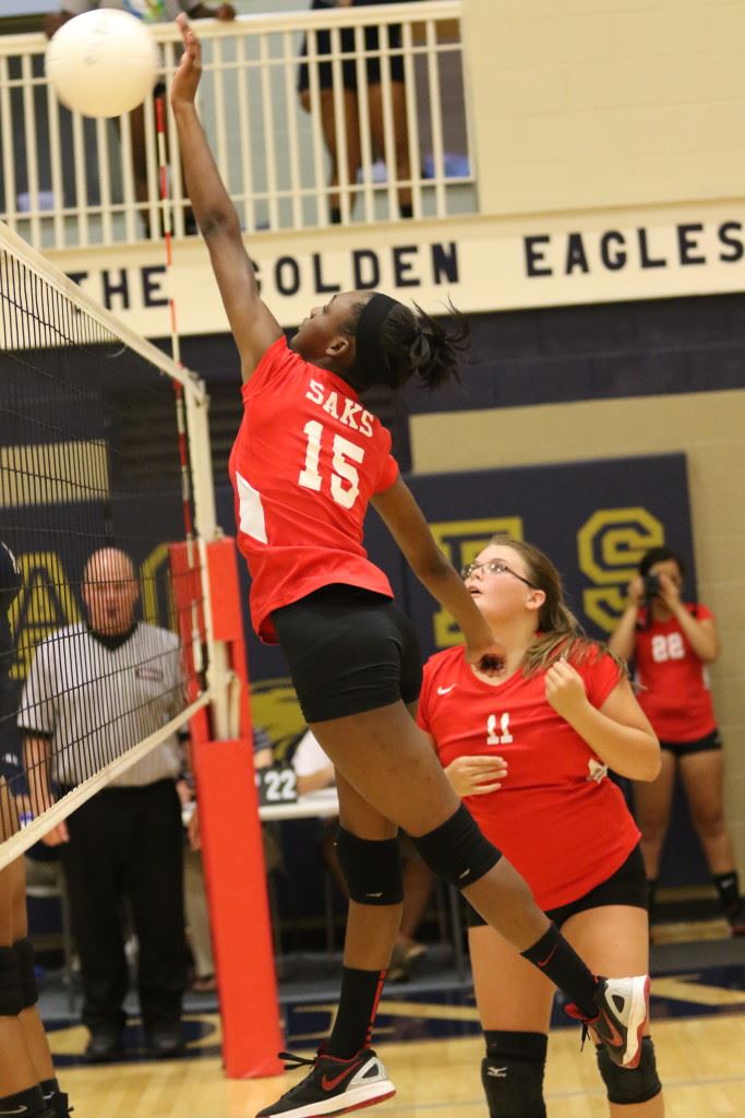 LaMonica Noel (15) sends a ball back over the Jacksonville side of the net as teammate Jaelyn Wilson watches intently. (Photo by Kristen Stringer/Krisp Pics Photography)  