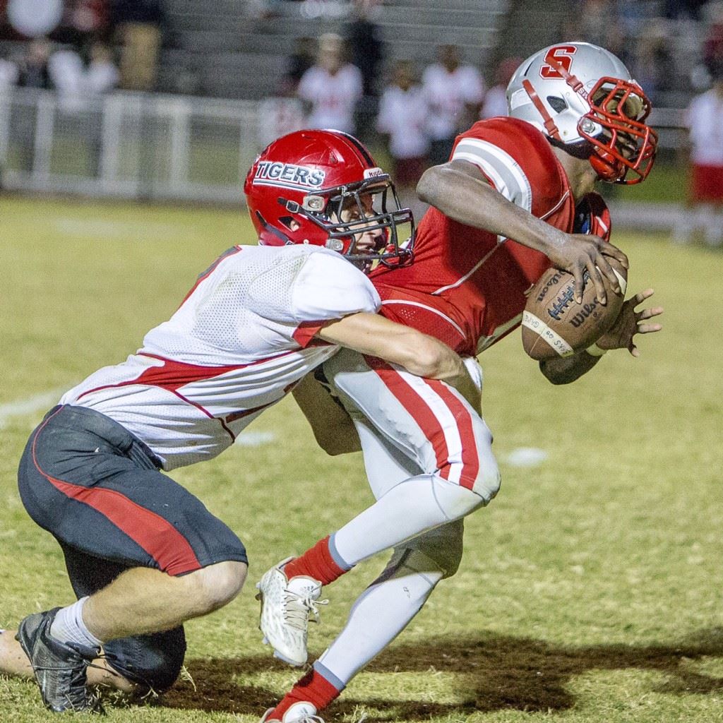 Cleburne County safety Trevor Houston wraps up Saks quarterback Quin Smith on the Wildcats' final play to secure the Tigers' region-title-clinching victory. (Photo by Jonathan Fordham)