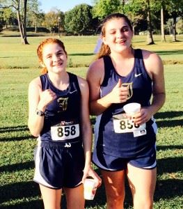 Two-time County girls champion Rebecca Hearn (L) and Jacksonville teammate Victoria Ashby enjoy some down time after the race. 