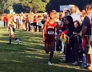 Anniston's Zebedee Lunsford sprints to the finish to win the Calhoun County boys cross country race for the second year in a row. On the cover, Lunsford and girls winner Rebecca Hearn share their mutual respect.