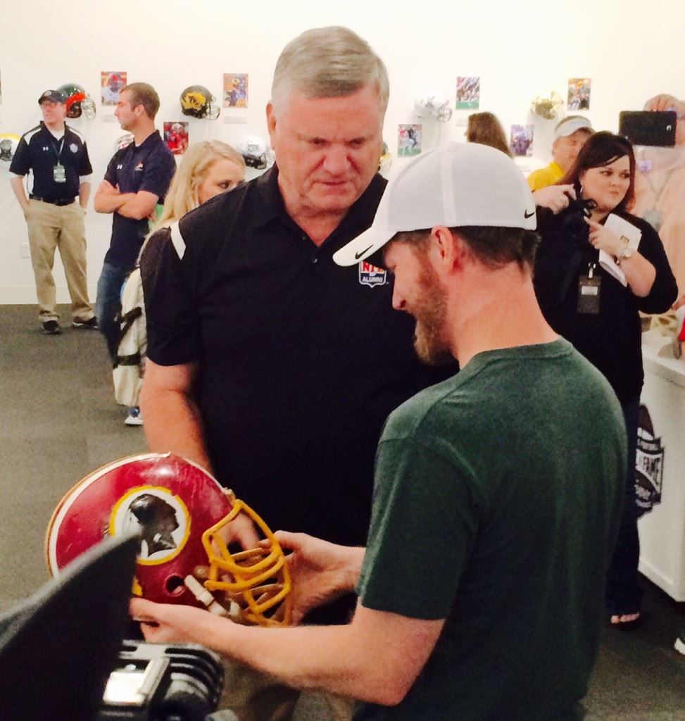 College football Hall of Famer Dave Butz (L) gives Dale Earnhardt Jr. the back story on his Washington Redskins helmet. It was the last helmet Butz wore in an NFL game.