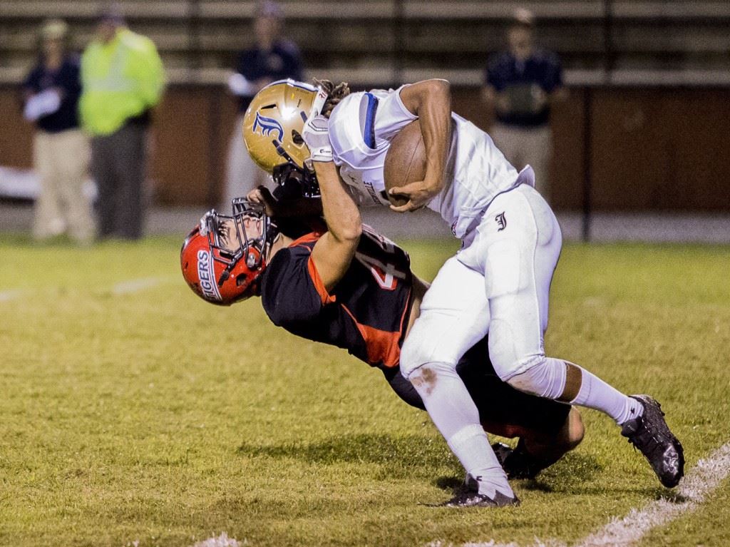 Cleburne County's Wade Dasinger (44) brings down Jacksonville's Tahj Kirkland. (Photo by Jonathan Fordham)