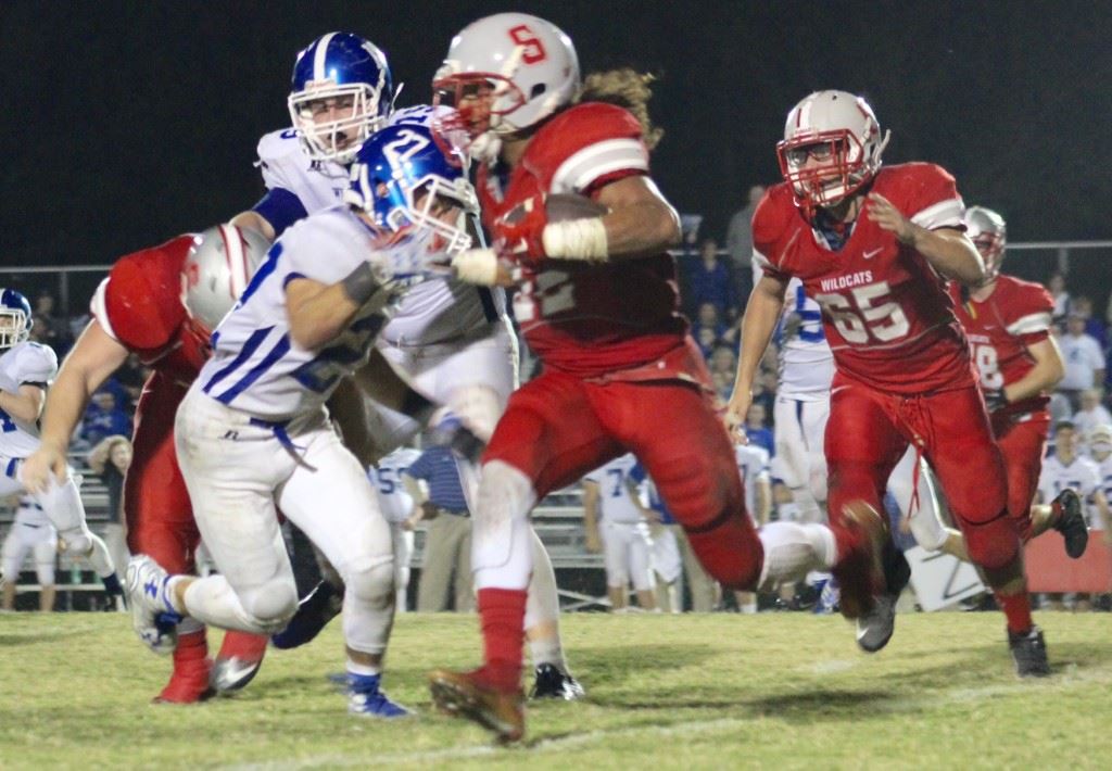 Bruising Saks running back Calvin Figueroa tries to get past West Limestone defender Coleton Smith during Thursday night's 4A playoff game. Figueroa rushed for more than 2,100 yards this season. (Photo by Ocala Honeycutt)