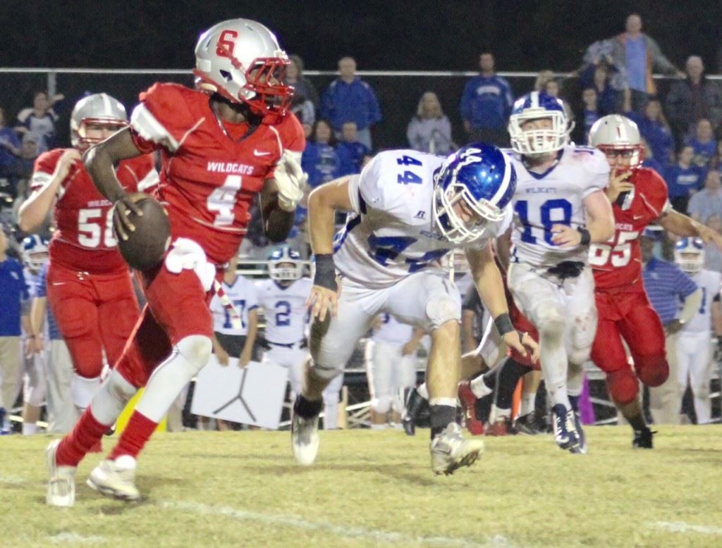 Saks quarterback Quin Smith (4) looks for running room while being pursued by West Limestone's Cody Shedd (44) and Tanner Walker. (Photo by Ocala Honeycutt) 