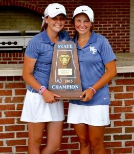 Layne Dyar (R) and her younger sister Hanna hold the state championship trophy White Plains' girls golf team won last spring.