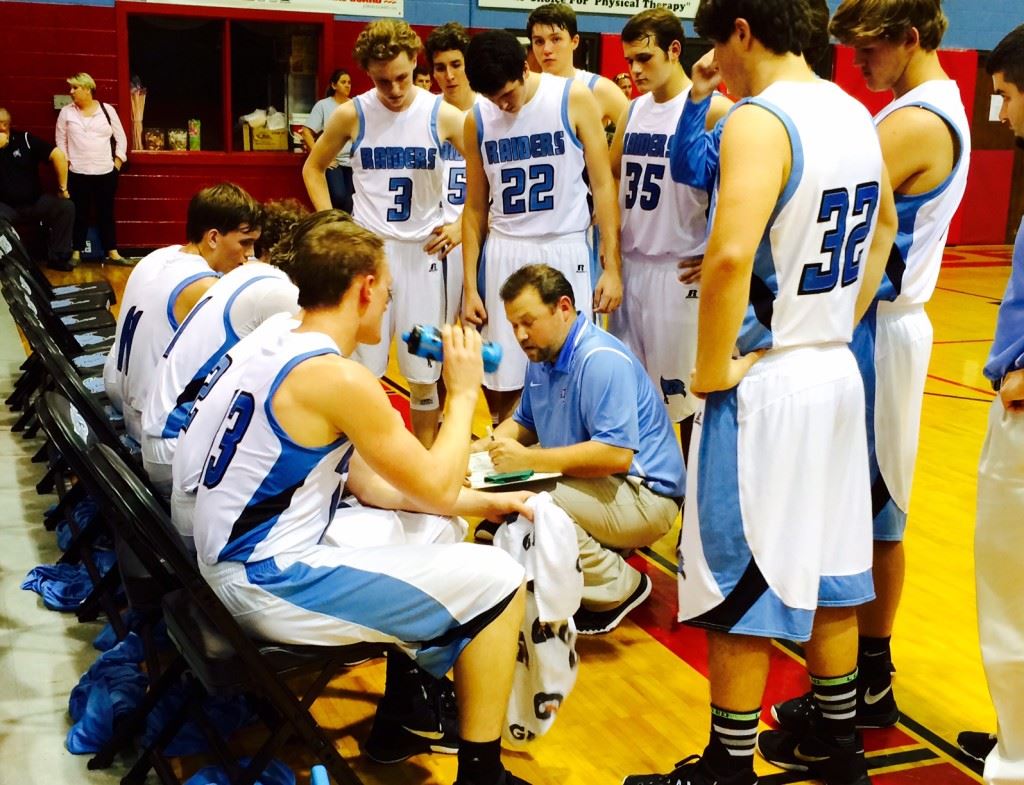 Marshall Smith (11) listens intently as first-year Pleasant Valley coach Ryan McCoy maps out a play during a timeout in Monday's season opener.