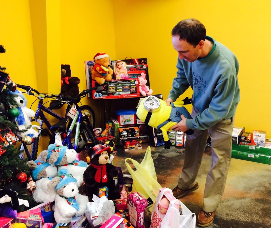 Pine Hill pro Cory Etter puts another donated toy under the tree as he prepares for Saturday's Toys for Kids Classic.