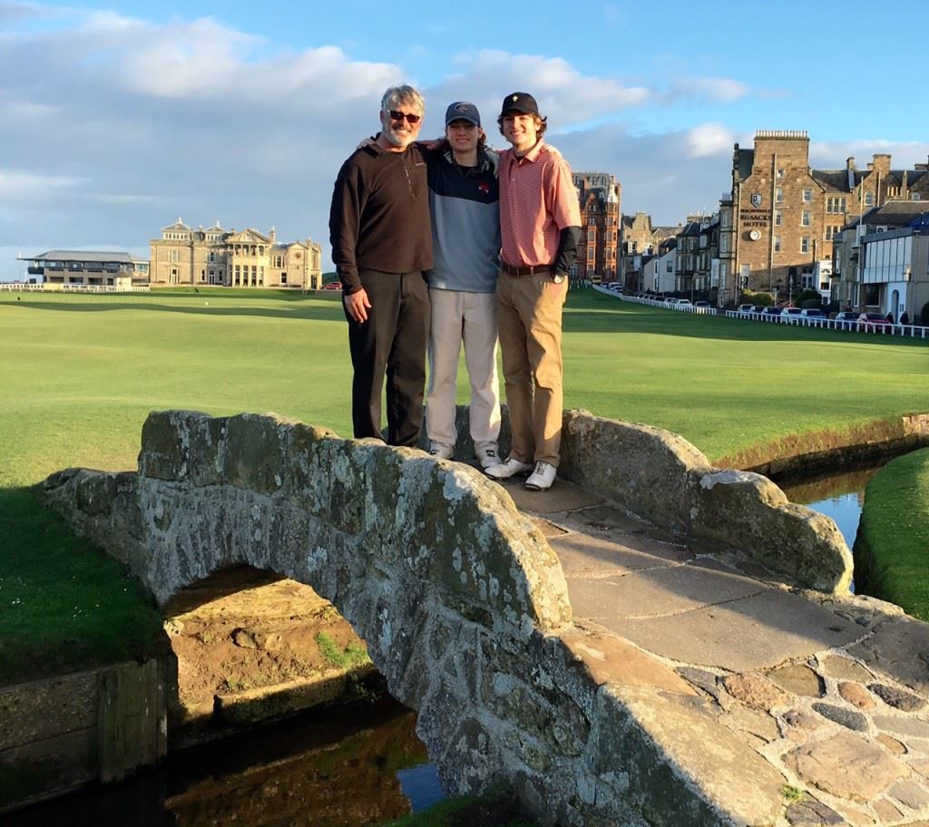 Anniston optometrist Rob Svensen and his sons Jack (center) and Ross pause as they cross the famous Swilcan Bridge on the Old Course at St. Andrews. On the cover, the Svensens huddle up on the first tee. Below, the group walks into the sunset at the end of a golf trip of a lifetime. (Photos by Rob Svensen)