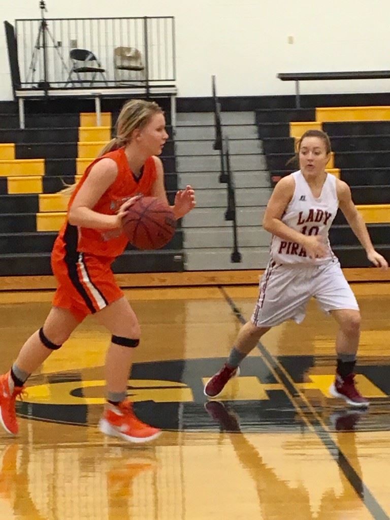 Alexandria's Timberlynn Shurbutt (L) brings the ball across midcourt against Boaz' Jericka Smith. (Photo by Jason Katz)