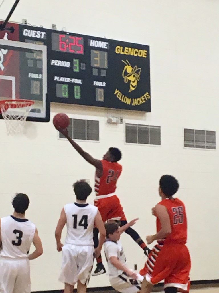 Alexandria's Caleb Young (24) drives to the basket against Glencoe. (Photo by Jason Katz)