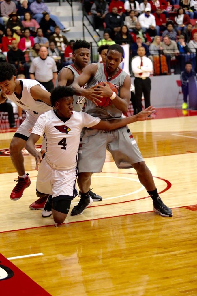 Boys tournament MVP DeQuan Ross takes control of a rebound despite the efforts of Sacred Heart's Murdock Simmons (4) in Saturday's boys County Tournament championship game. (Photo by Kristen Stringer/Krisp Pics Photography)