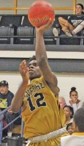 Oxford guard Eugene Leonard scored a double-double against Cherokee County. On the cover, Warriors guard Joel Wester makes his move to the basket. (Photos by Shannon Fagan)