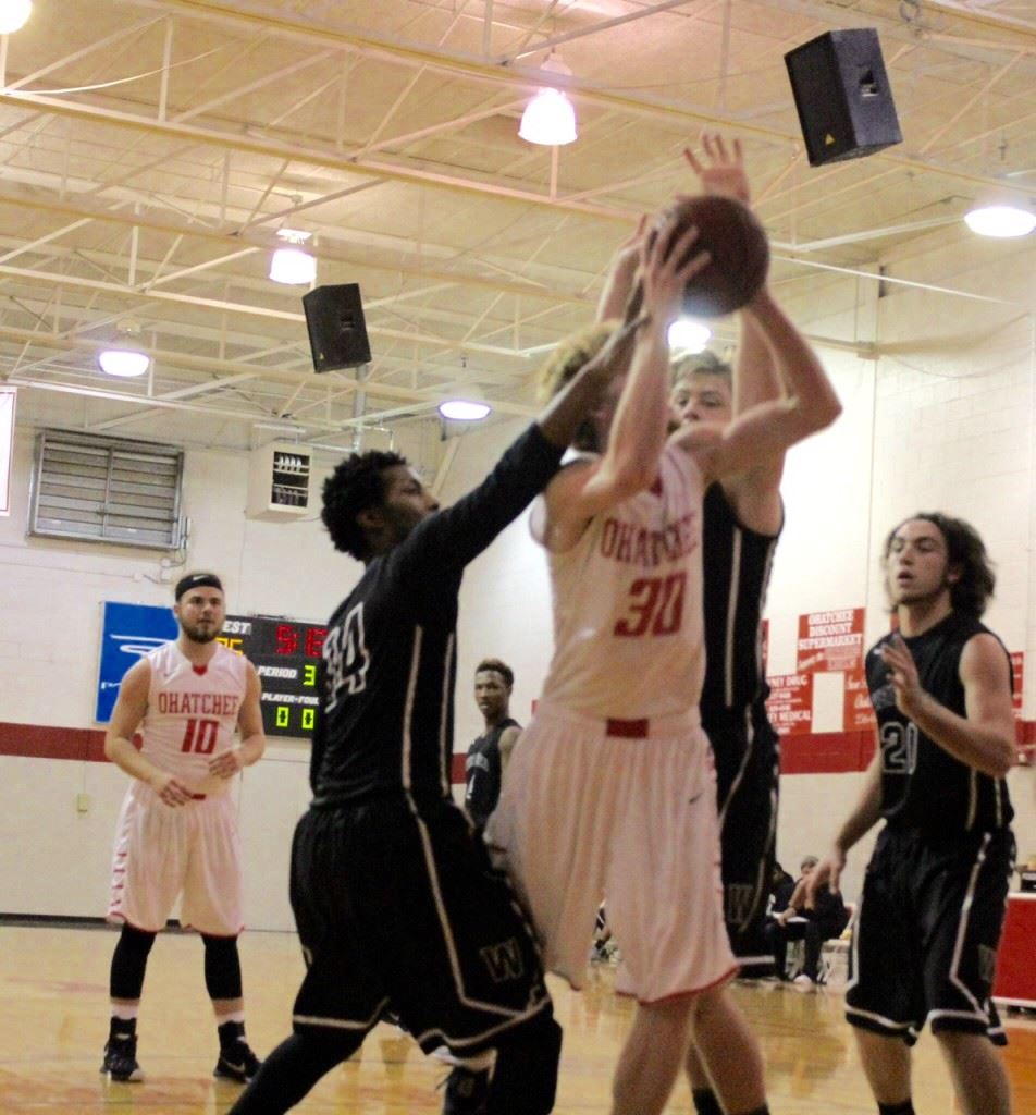 Ohatchee's Brian Jennings (30) draws a lot of attention from Wellborn defenders as he makes a move under the basket Monday. (Photo by Carrie Howell)