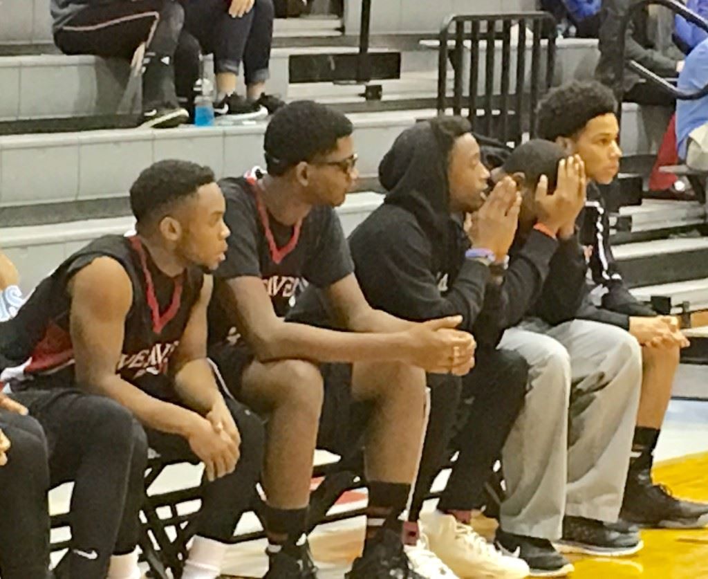 Weaver senior guard Jalen Heath (center) watches the action unfold in Thursday's game with Pleasant Valley from a coach's perspective as he awaits medical clearance to return to action.