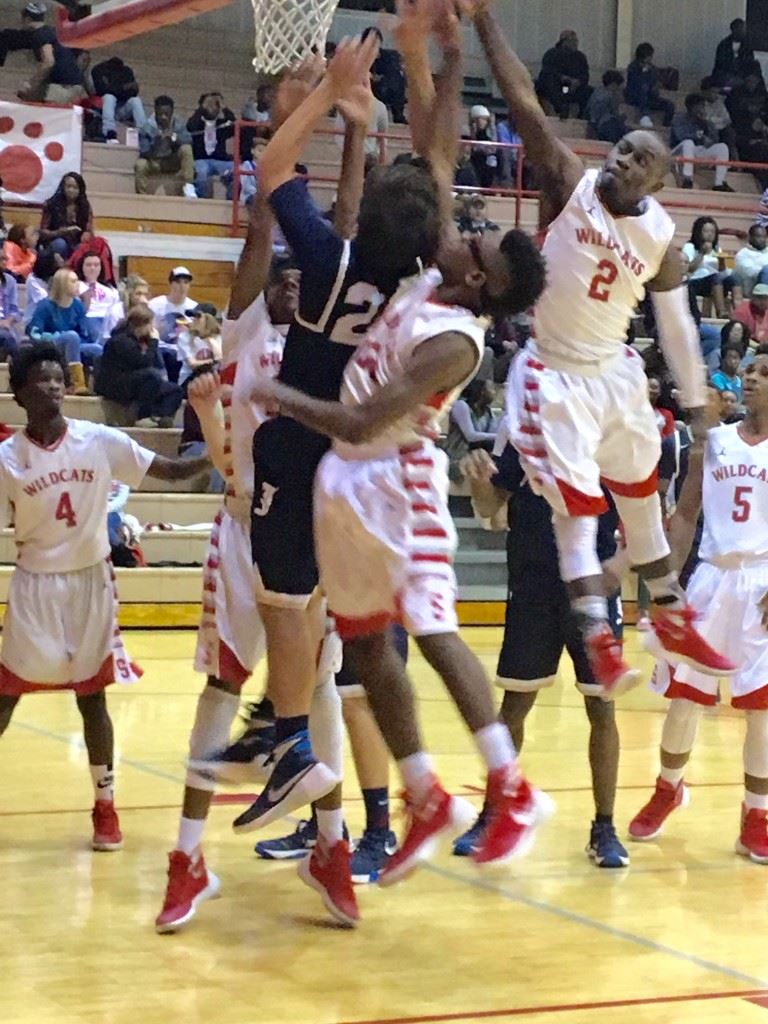 Saks' Demetrius Powell (2) comes over the top to help the Wildcats completely surround Jacksonville's Blake Morris under the basket Tuesday night. (Photo by Jason Katz)