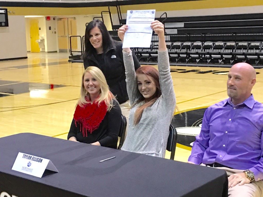 Versatile Oxford softball player Taylor Ellison celebrates her signing with a Mississippi junior college to continue her career. She was joined by head coach Wendy McKibbin, pitching coach Leslie Pickett and her dad Anthony.  