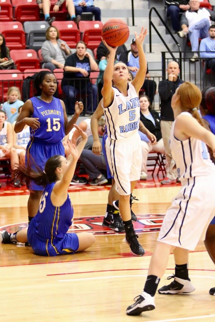 Pleasant Valley's Atleigh Brannon (5) attacks the basket against Piedmont. On the cover, PV's Kara Perry (00) and Piedmont's Brooke Perry get to a loose ball at the same time. (Photos by Kristen Stringer/Krisp Pics Photography)