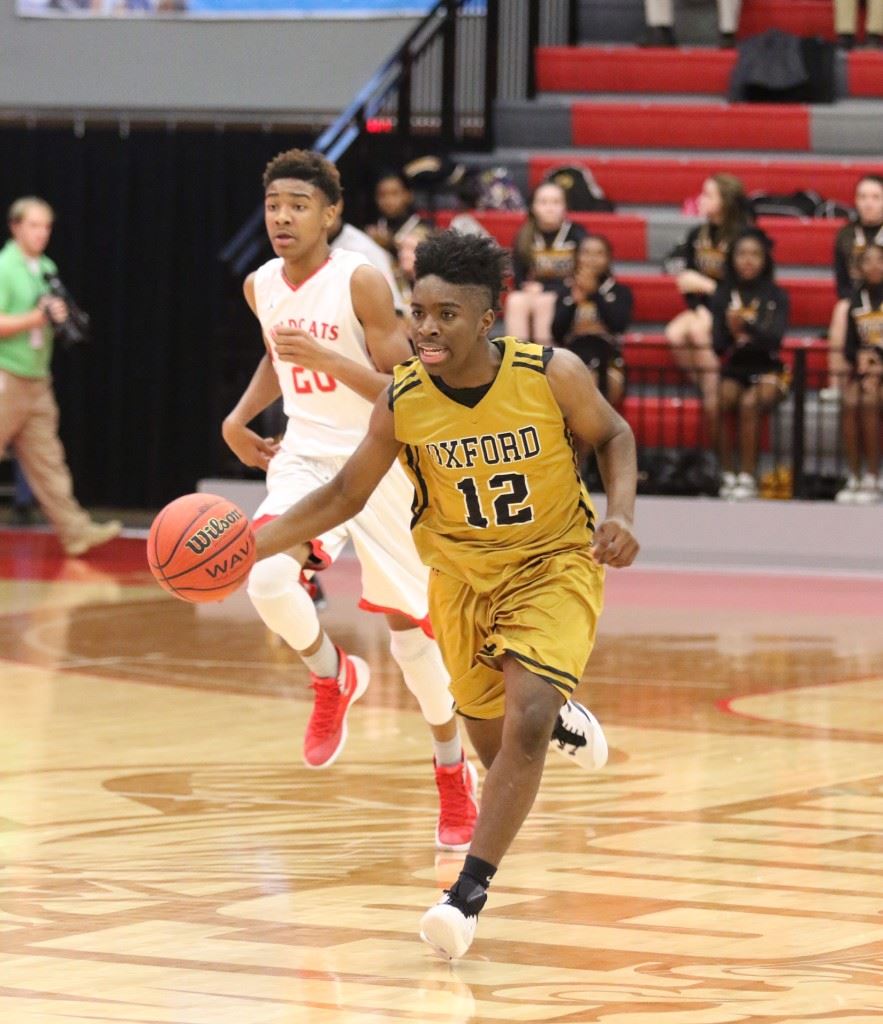 Eugene Leonard is just a freshman, but he has developed into a reliable point guard for the Oxford basketball team. On the cover, Jalen Moore (2) lunges for a steal against Saks. (Photos by Kristen Stringer/Krisp Pics Photography)