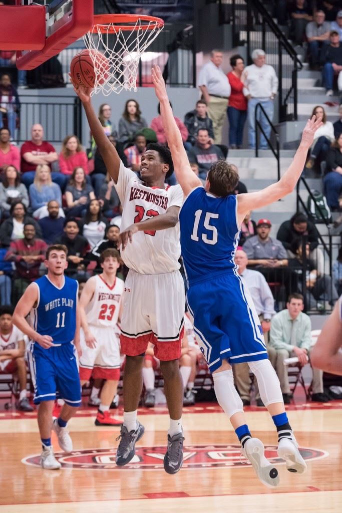 Westminster Christian's Tysean Whitehead (22) goes around the defense of Michael McGuirk for two of his 21 points Saturday in the Class 4A Northeast Regionals. (Photos by Stephen Miller)