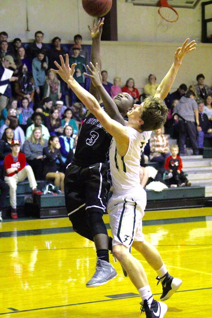 Faith Christian's Jack Sills (R) moves in to contest the shot of Wellborn's Eric Johnson during Friday's game. (Photo by Carey Jenkins)