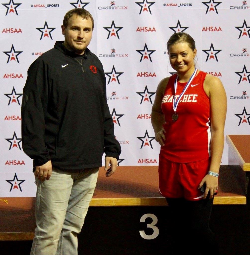Ohatchee senior Courtney Poole (R) stands with coach Casey Howell after finishing third in the 1A-3A girls shot put Friday at the state indoor track championship.