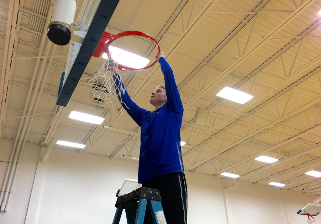 Tournament MVP Bayley Blanchard grabs his piece of the net after leading Piedmont to its second straight area championship. On the cover, Blanchard (21) is joined by teammates (from left) Easton Kirk, Darnell Jackson and Austin Brazier on the all-tournament team.