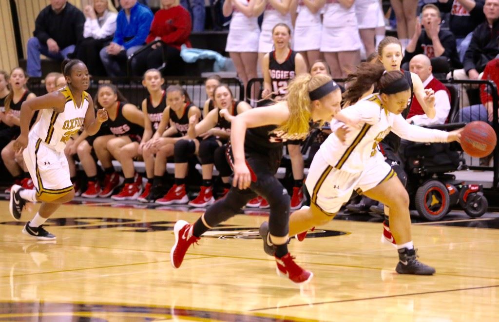 Oxford's Winter Taylor (R) races up the floor against an Albertville defender. Taylor had 13 points, six rebounds and three steals, but the Lady Yellow Jackets fell by one. (Photos by Kristen Stringer/Krisp Pics Photography)