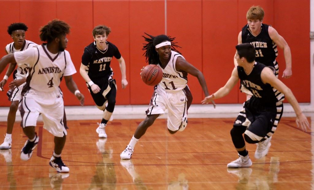 Hakeem Ross (11) leads Anniston on the break against Hayden. On the cover, Bulldogs coach Schuessler Ware discusses a plan with his coaches and players in his last home games as Anniston's basketball coach. (Photo by Kristen Stringer/Krisp Pics Photography)