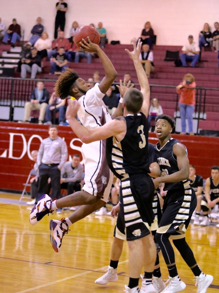 Anniston's Marrio Dobbins puts up a shot in traffic in Tuesday night's subregional game with Hayden. (Photo by Kristen Stringer/Krisp Pics Photography)