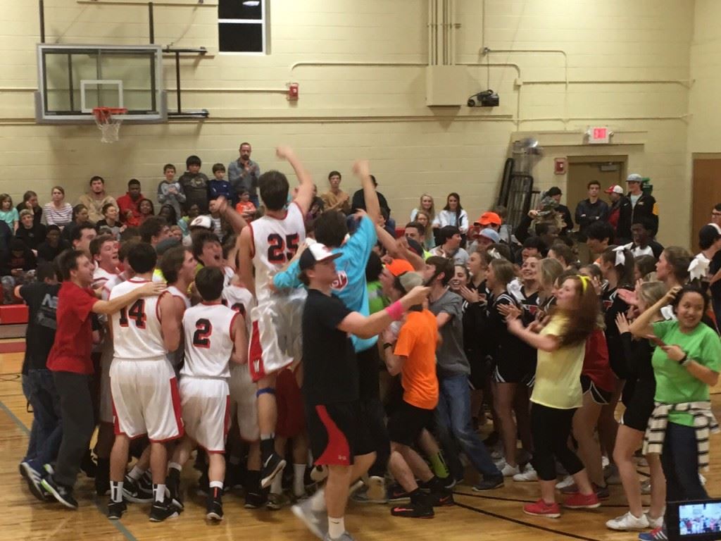 Westbrook Christian players and fans rush the floor after the Warriors defeated Weaver Tuesday to earn a trip to the Northeast Regionals.