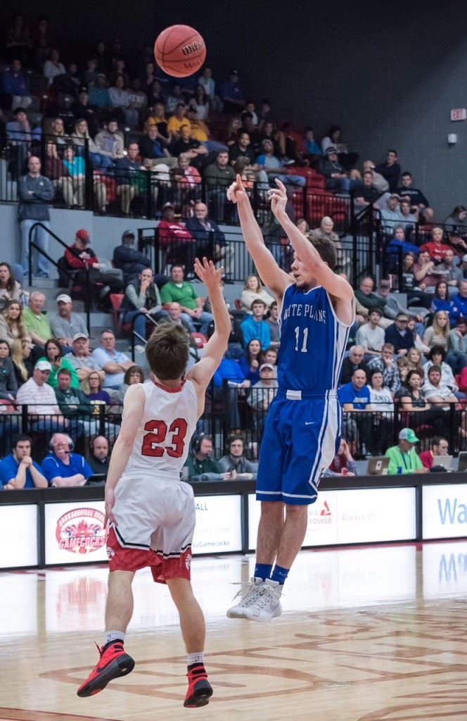 Eli Hightower launches a long-range 3-pointer over Westminster's John Kendall Saturday. The White Plains captain had one 3 among the seven points in the final game of his high school career. (Photo by Stephen Miller)