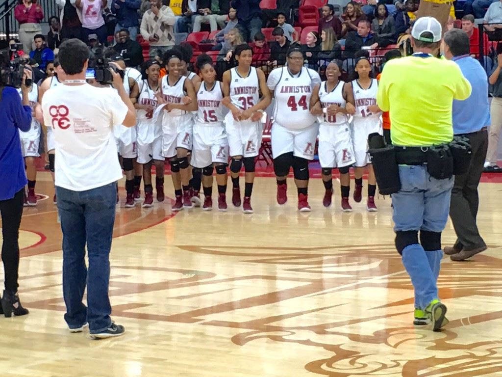 The Anniston girls basketball team comes to center court arm-in-arm to claim their regional trophy. On the cover, Raven Cooley wears her reminder to keep believing. (Cover photo by Kristen Stringer/Krisp Pics Photography)