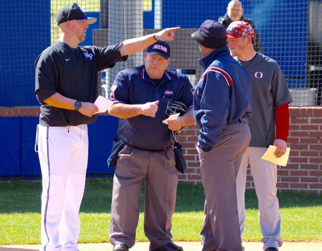 Wes Henderson (L) points out something in the left-field corner to the umpires and Ohatchee coach Blake Jennings (R) while going through the ground rules at home plate before his first game as a varsity baseball coach Friday. (Photos by Tammy Morrow)