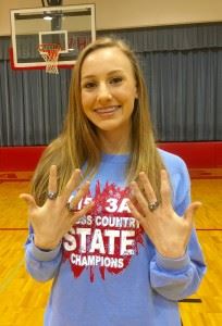 Rachel Faucett displays her three state championship rings, the newest two she received Tuesday.