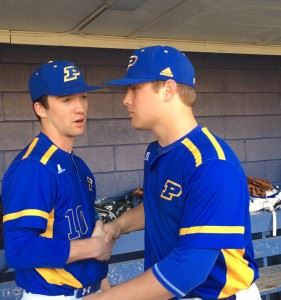 Closer Caleb Morrow (L) congratulates starter Taylor Hayes in the dugout after the Piedmont left-hander's strong start in Tuesday's area opener.